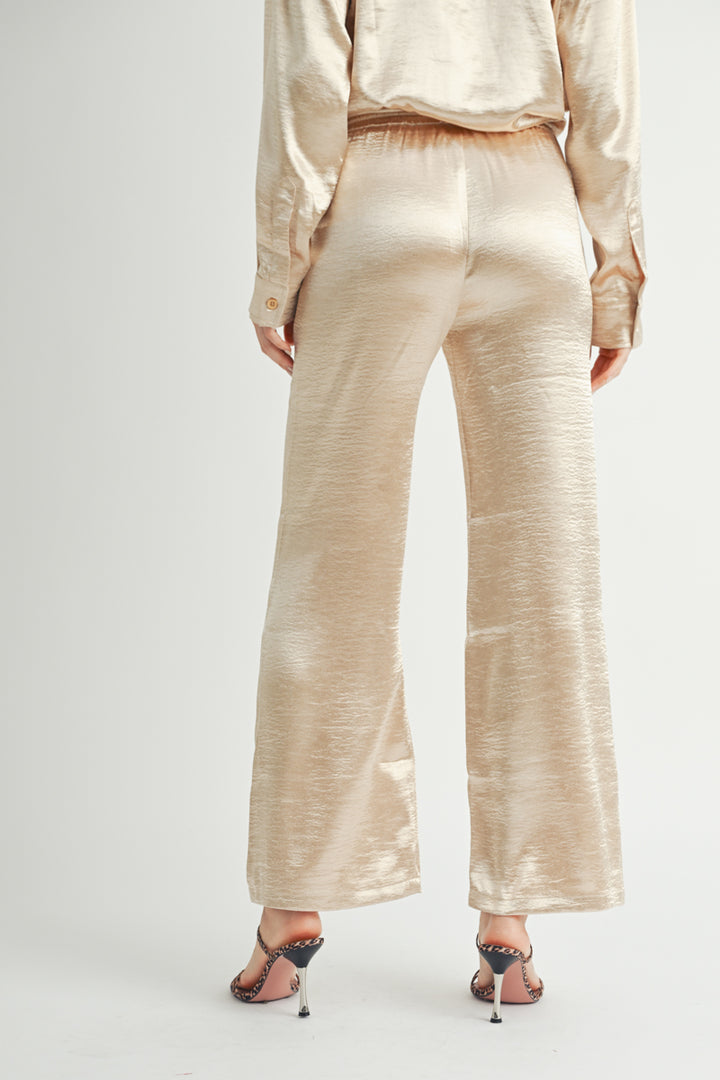 Women Wholesale brand Metallic Pants The elastic waist ensures a customizable and flattering fit, while the wide-leg silhouette adds a touch of modern flair.