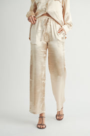 Metallic Pants The elastic waist ensures a customizable and flattering fit, while the wide-leg silhouette adds a touch of modern flair.